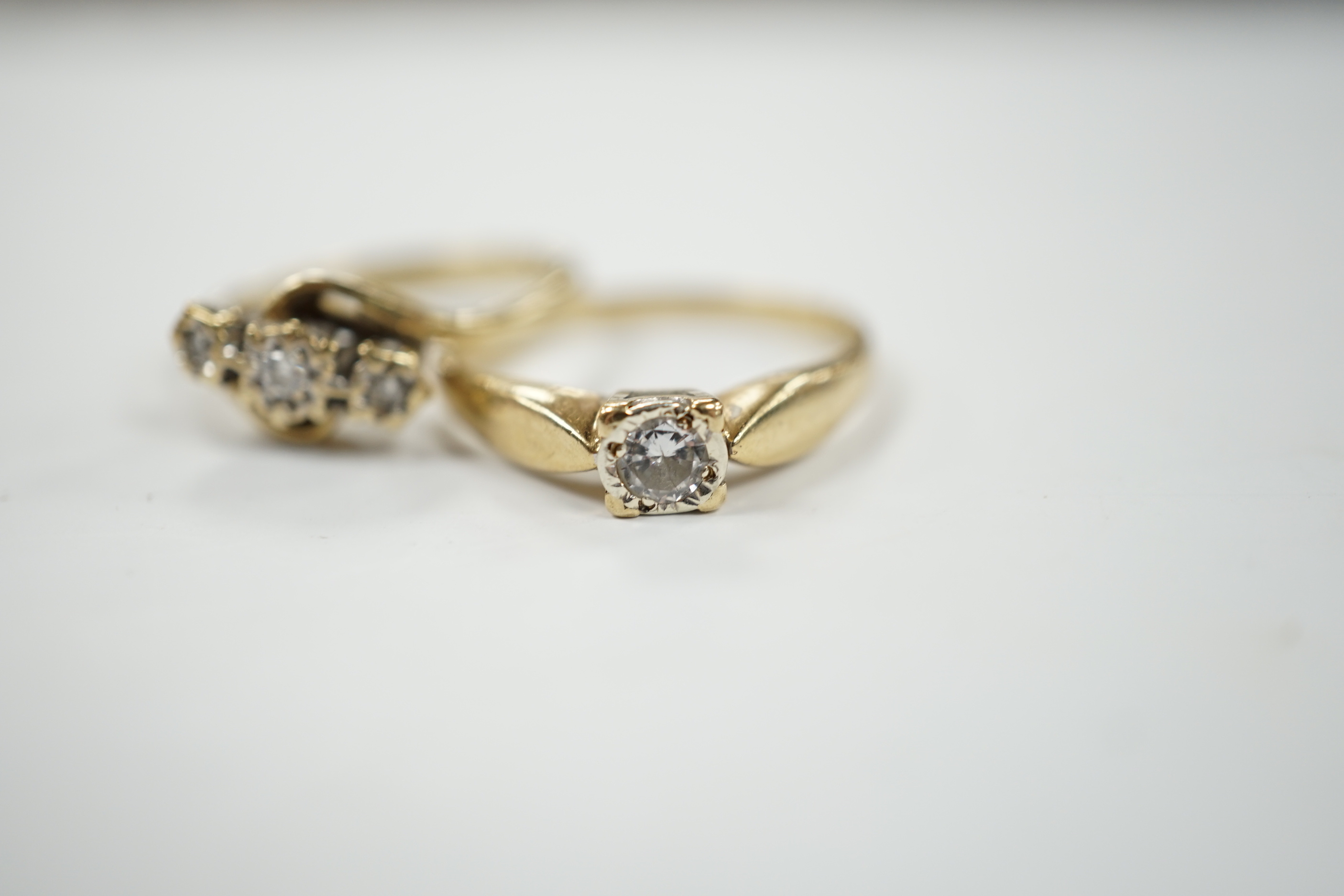 Two 9ct gold and diamond set rings including three stone and solitaire